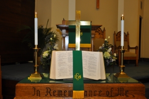 Bible and cross on the communion table